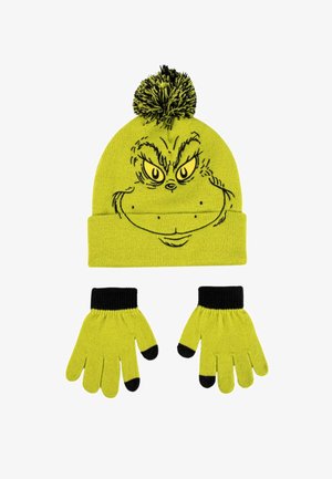 Groene gebreide muts met zwarte pompon, voorzien van een Grinch-gezicht, gekoppeld aan bijpassende groene handschoenen met zwarte manchetten en vingertoppen.