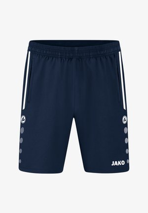 Granatowe sportowe spodenki z białymi paskami po bokach, elastycznym pasem, przednimi kieszeniami, okrągłym logo oraz napisem "JAKO" na prawej nodze.