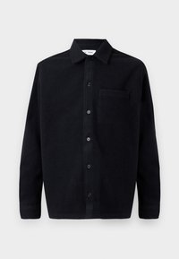 Black wool shirt with a button-down collar, long sleeves, and a patch pocket on the left side. Smooth texture with subtle softness.
