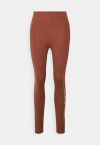Leggings marron en matière extensible, dotés d'une taille haute et d'un imprimé logo blanc sur le côté. Texture lisse et design pleine longueur.