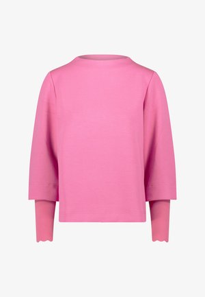 Top a maniche lunghe rosa con scollo rotondo e polsini smerlati, realizzato in tessuto morbido con una texture liscia e una vestibilità rilassata.