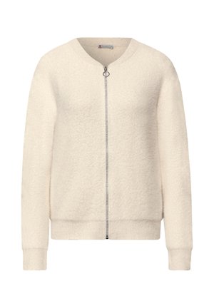 Cardigan con cerniera color crema, morbido e peloso, con polsini e orlo a coste, dotato di un piccolo cursore rotondo.