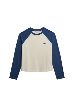 T-shirt z długim rękawem w kremowym kolorze z niebieskimi rękawami raglanowymi. Posiada okrągły dekolt oraz małe logo na piersi. Miękka tekstura.