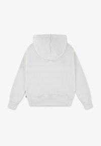 Felpa bianca in pile con cappuccio, polsini e orlo a costine. Texture liscia, senza motivi visibili. Piccola etichetta sul lato. Vista posteriore mostrata.