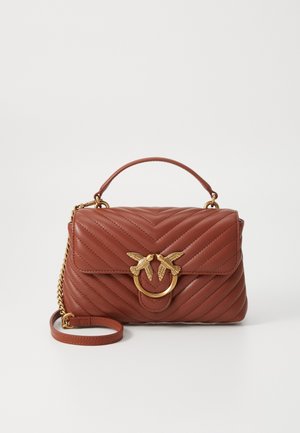 Sac à main matelassé en cuir marron avec poignée supérieure et fermoir doré en forme d’oiseau, avec bandoulière amovible ornée de détails en chaîne dorée.