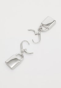 Silver-tone earrings featuring a lock design with a shiny finish, circular links, and a lever-back closure. Smooth texture, geometric shape.