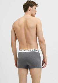 Grau Baumwollboxershorts mit einem weißen Bund, auf dem "JACK & JONES" steht. Der Stoff scheint weich zu sein und hat eine glatte Textur.