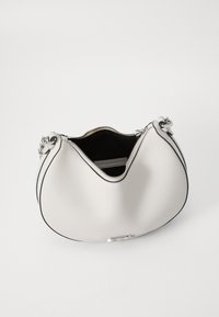 White leather handbag with a curved silhouette, black lining, silver hardware, and a zipper closure. Features a subtle logo detail.