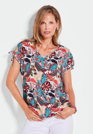 Top floreale con scollo a V e maniche corte, caratterizzato da un motivo multicolore di fiori e foglie su un tessuto leggero. Le finiture includono dei nastri alle maniche.