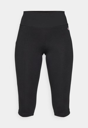 Black cropped leggings made from stretchy fabric with a high waistband. Features subtle stitching details and a small logo on the side.