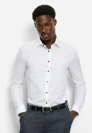White button-up shirt with blue buttons, long sleeves, and a standard collar, paired with gray trousers and a black belt. Smooth texture.