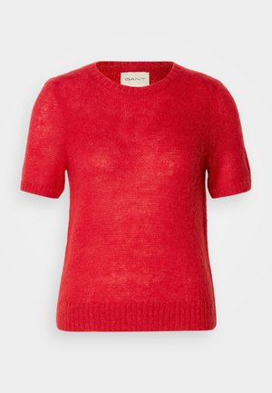 Rdeča kratko rokavna pulover iz lahkega pletenega materiala s krožnim izrezom in rebrastim robom, s rahlo teksturirano površino.