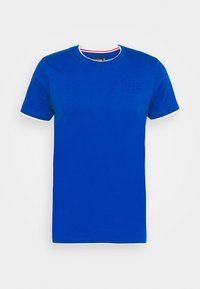 Niebieska bawełniana koszulka z krótkim rękawem, okrągłym dekoltem i białym wykończeniem. Posiada dyskretną naszywkę z logo na piersi.