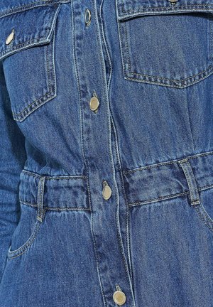 Denim dress in blue with a collared neckline, front button closure, two chest pockets, and a belted waist for shape definition.