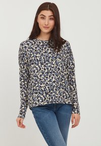 Langärmliges Oberteil in Creme mit einem blauen und schwarzen Leopardenmuster, mit einem lockeren Schnitt und rundem Ausschnitt. Weicher, dehnbarer Stoff.