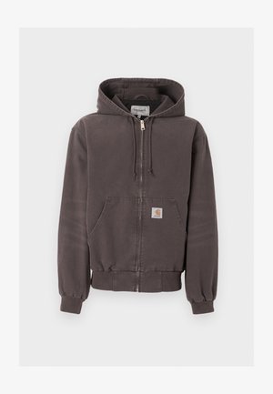 Tamsiai pilkas užsegamas bliuzonas su priekinėmis kišenėmis, raištelio tipo gaubtu, ribotais rankogaliais ir apačia bei mažu logotipo lopu kišenėje.