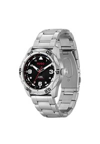 Kovinska wristwatch iz nerjavečega jekla z črnim številčnico, belimi oznakami in rdečimi detajli. Ima rotirajočo obrobo in je vodoodporen do 50 metrov.