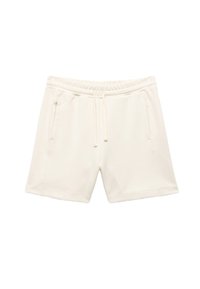 Crème-kleurige katoenen shorts met een elastische tailleband, verstelbaar trekkoord en twee zijzakken. Soepele textuur, lengte tot halverwege de bovenbenen.