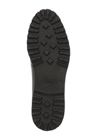 Black rubber shoe sole with deep treads and diamond-patterned grips. Features embossed brand name. Textured surface for traction.