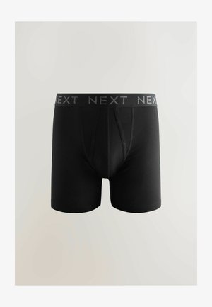 Boxer shorts noirs en tissu doux, avec une large ceinture élastique portant le logo "NEXT". Le design comprend une braguette traditionnelle.