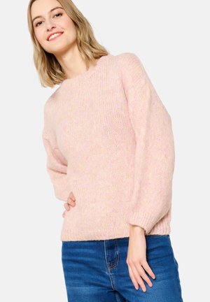 Pink knitted sweater with a round neck, loose sleeves, and ribbed hem, paired with blue jeans. Soft texture with subtle variation in color.