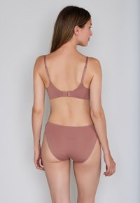 Brown bikini set featuring a smooth, textured bra with adjustable straps and hook closure, paired with matching high-waisted bottoms.