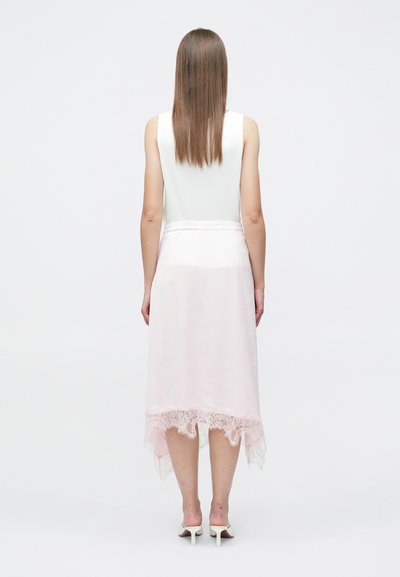 Světle růžové šaty s rozšířeným předním a prodlouženým zadním lemem, průsvitnou látkou a krajkovou ozdobou na spodním okraji. Pružné v pase, bez rukávů a s hladkou texturou.