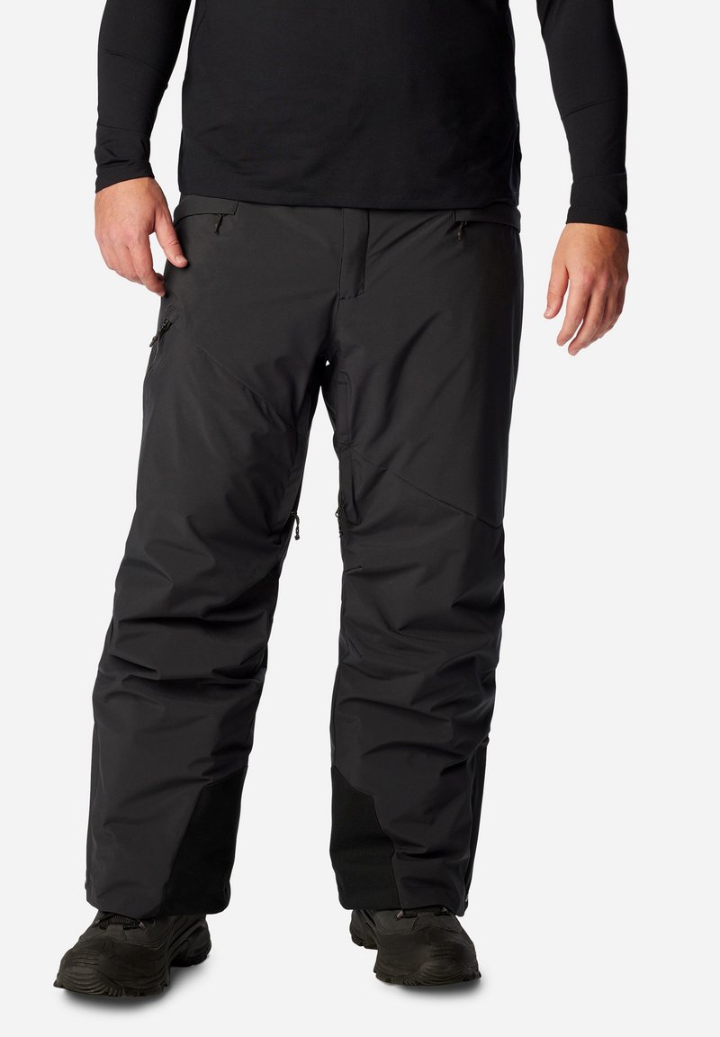 Schwarze wasserdichte Skihosen mit Reißverschlusstaschen, verstellbaren Knöchelöffnungen und einer lockeren Passform, aus robustem, strukturiertem Obermaterial.