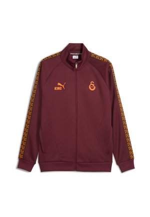 Maroon zip-up jacket made of smooth fabric. Features contrasting orange branding and geometric patterned trim on the shoulders.