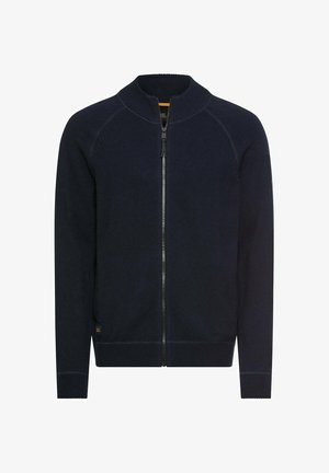 Marineblå sweater med lynlås og høj krave, ribstrikkede manchetter og kant. Har en glat strikket struktur og kontrasterende lynlås.