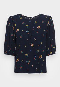 Marineblauwe blouse met bloemrijke borduurwerk in rood, geel en paars, voorzien van korte pofmouwen en een back keyhole detail.