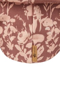 Floral-patterned cap in dusty rose and light pink fabric. Features rounded shape, soft texture, and a small branded leather tag.