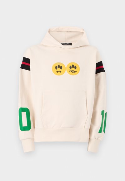 Cream hoodie with front pocket, featuring two yellow cartoon faces, black and red striped shoulder accents, and green numbers "10" and "0" on sleeves.
