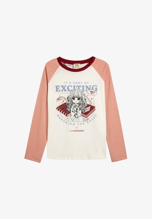 Long-sleeve t-shirt with a white body and pink raglan sleeves. Features an illustrated girl and text, "IT'S SORT OF EXCITING BREAKING THE RULES."