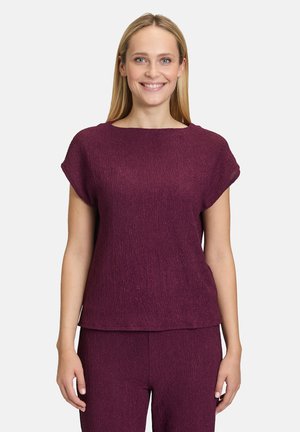 Top a maniche corte, fluido, di un ricco colore bordeaux. Tessuto testurizzato con vestibilità rilassata e un leggero scollo a barca. Design semplice e classico.