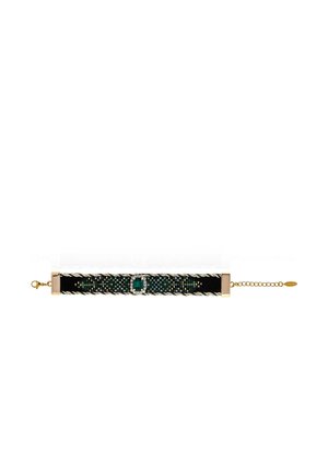 Black velvet choker with gold chain, green square gemstone center surrounded by small clear stones, and woven metallic detail along the band.