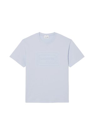 T-shirt a maniche corte e girocollo di colore azzurro chiaro con logo Lacoste Paris in rilievo al centro del petto.