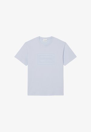 T-shirt a maniche corte e girocollo di colore azzurro chiaro con logo Lacoste Paris in rilievo al centro del petto.