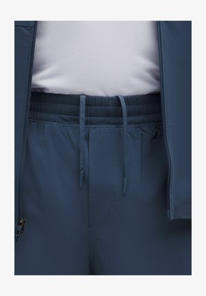 Sötétkék sportdzseki sima textúrával és rugalmas derékkal. Cipzáras zsebet és állítható húzózsinórokat tartalmaz.