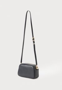 Black leather rectangular crossbody bag with adjustable strap and gold zipper and buckle details, shown against a plain light background.