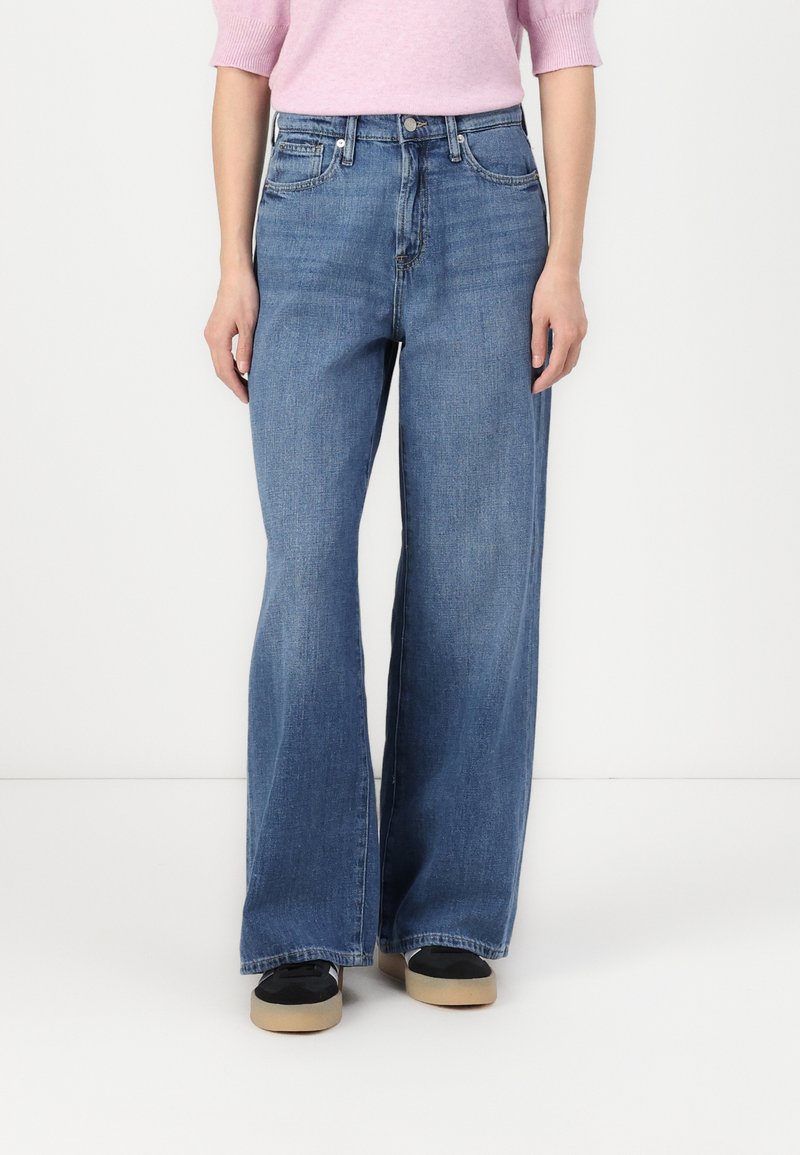 Blue wide-leg jeans with a high waist, made from denim fabric. Features two front pockets and a classic five-pocket design.