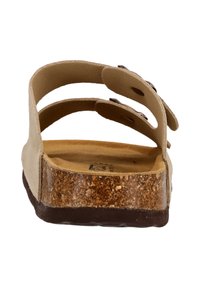 Beige sandaler med två justerbara remmar, korkfotbädd och en brun gummisula. Slät textur med cirkulära utskärningar för andningsförmåga.