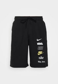 Černé šortky na stahování s šesti různými logy Nike tištěnými vertikálně na pravé noze v bílé a žluté barvě.