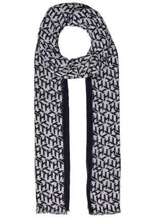 Długi prostokątny szalik z czarno-białym geometrycznym wzorem i czarnymi pionowymi paskami wzdłuż brzegów, z lekko postrzępionymi końcami.