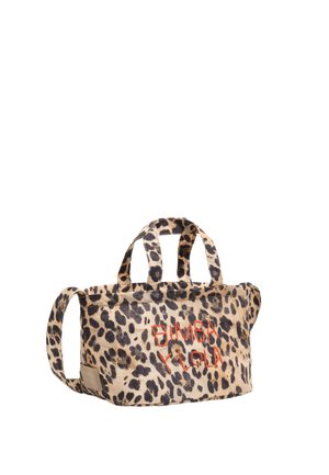 Mała torba materiałowa w panterkę z dwoma krótkimi uchwytami i jednym długim paskiem, z pomarańczowym, wyszywanym logo "Bimba Y Lola".