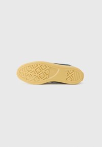 Pantof black cu un superior din țesătură texturată și o talpă din cauciuc natural cu un model geometric pentru aderență și durabilitate.