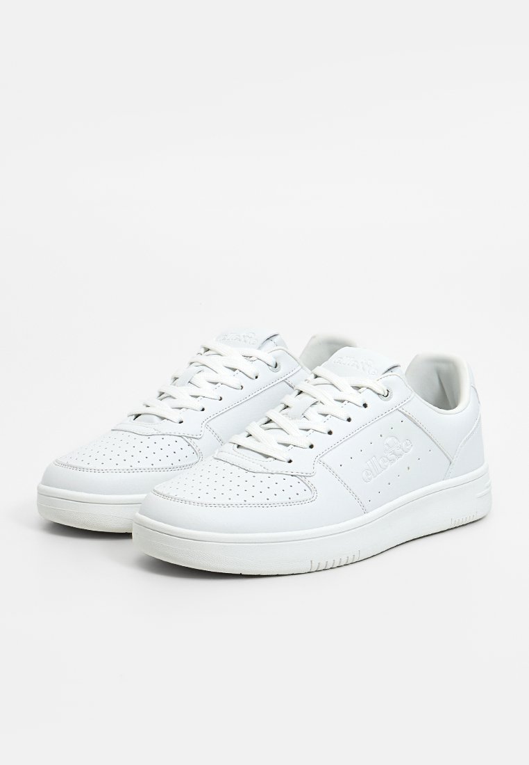 Zapatillas de piel blanca con una caja de puntera texturizada, perforaciones para transpirabilidad y cordones planos. Marca visible en el lateral y la lengüeta.