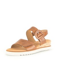 Brown leather wedge sandals with two wide straps, adjustable buckle, cork detailing on the wedge, and a white rubber sole.