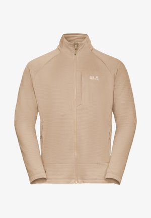 Giacca in pile beige con tessuto strutturato, cerniera completa, collo alto e tasca sul petto a sinistra. Presenta il logo Jack Wolfskin sul fianco.