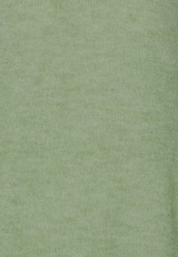 Weiches grünes gestricktes Gewebe mit einer gleichmäßigen Textur und einem leichten Glanz, das subtile Farbvariationen aufweist.